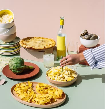 Friends sharing plates of food around a table